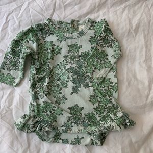 Beautiful green floral organic cotton onesie by Kate Quinn with ruffles